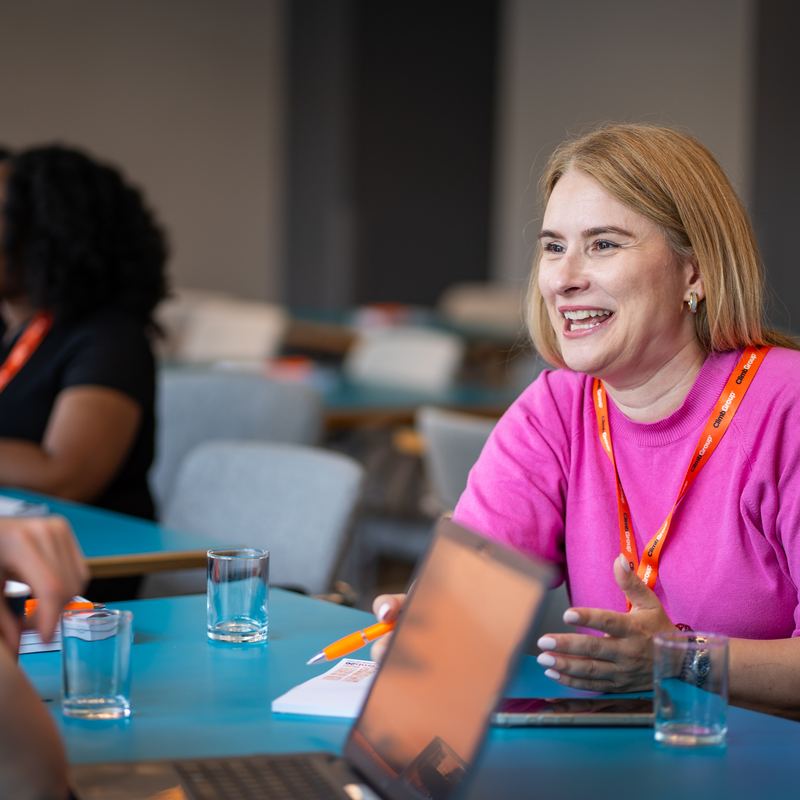 A delegate laughing at a roundtable
