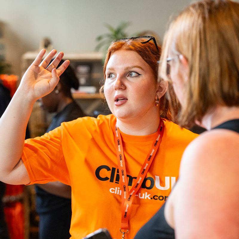 A ClimbUK volunteer waving to the crowd