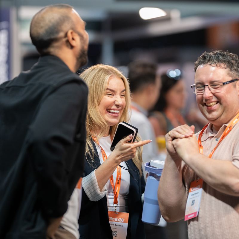 Three people laughing on the expo floor