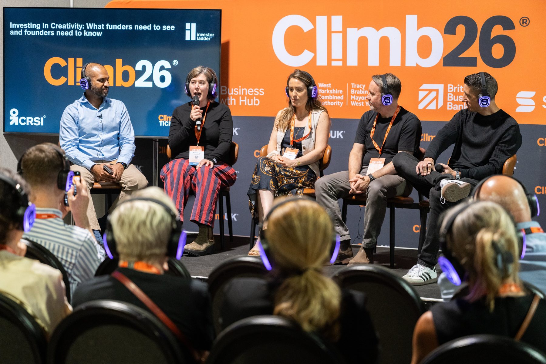 A panel on the Climb26 stage with the audience listening in the foreground